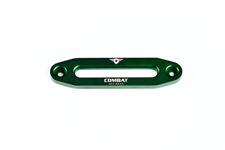 A green aluminum fairlead designed for use with synthetic winch ropes, featuring the Combat Off Road logo engraved in white on the front. The logo includes a shield with a star and winged accents, with the words "Combat Off Road" beneath it. The fairlead has a sleek, durable design with two bolt holes for secure mounting on Jeep bumpers.