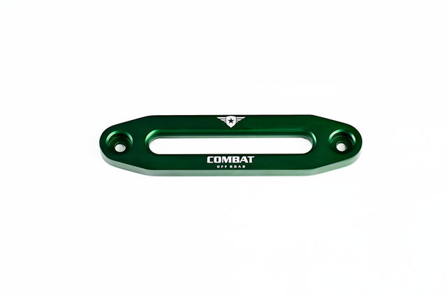 A green aluminum fairlead designed for use with synthetic winch ropes, featuring the Combat Off Road logo engraved in white on the front. The logo includes a shield with a star and winged accents, with the words "Combat Off Road" beneath it. The fairlead has a sleek, durable design with two bolt holes for secure mounting on Jeep bumpers.