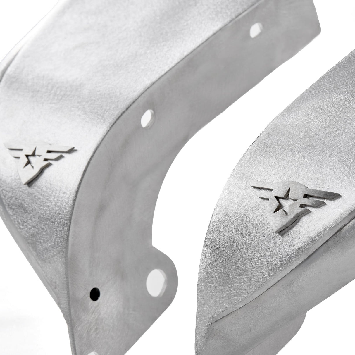 Close-up view of raw aluminum front fender flares for Jeep Wranglers, highlighting the natural metal finish and precision detailing. Each fender includes pre-drilled holes for easy installation and removable, paintable Combat Off Road logos near the edges. Designed for customization, durability, and off-road performance.