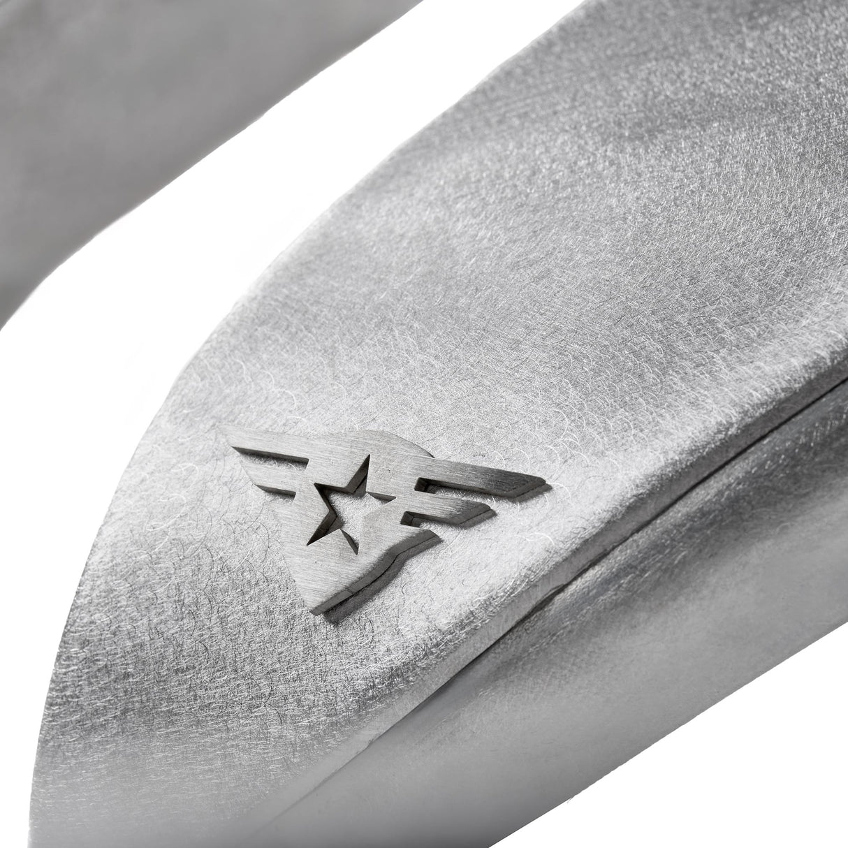 Close-up view of a raw aluminum front fender flare for a Jeep Wrangler, highlighting the natural metal finish and the removable, paintable Combat Off Road logo near the edge. The surface texture and precise detailing emphasize durability and customization potential for off-road performance.