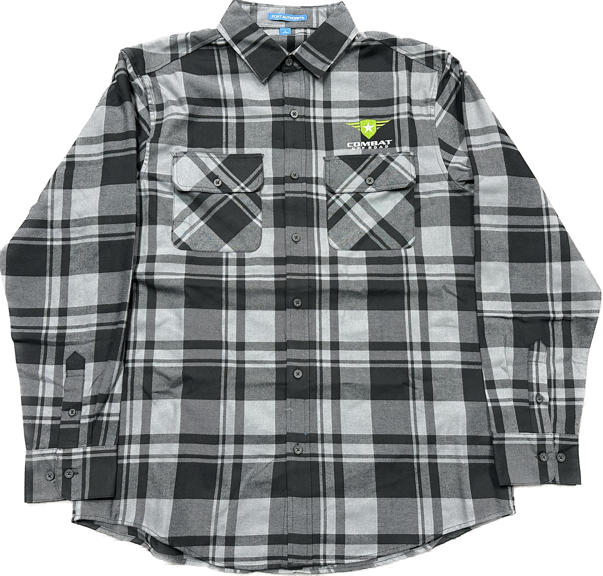 A black and gray plaid shirt featuring the Combat Off Road logo embroidered on the upper left chest. The logo includes a green shield with a white star and winged accents, accompanied by the text "Combat Off Road" in white. The shirt has a button-up design with two front chest pockets and long sleeves, offering a rugged yet comfortable style