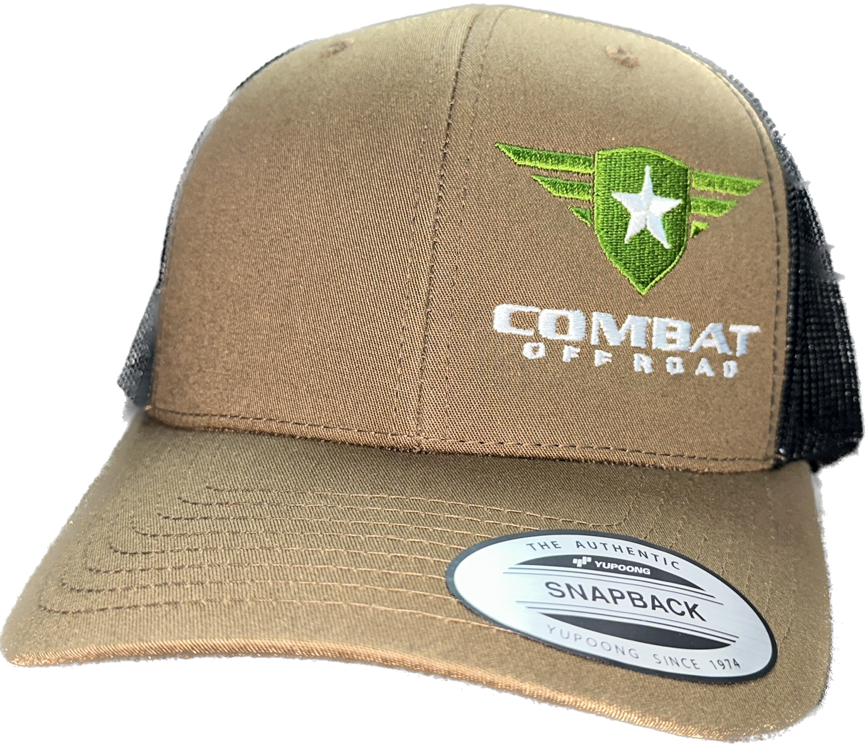 A tan and black trucker-style snapback hat with the Combat Off Road logo embroidered on the front. The logo features a green shield with a white star and winged accents, accompanied by the text "Combat Off Road" in bold white lettering. The front panel is tan, and the mesh back is black, with a sticker on the brim that reads "The Authentic Snapback". The hat has a curved brim for a comfortable fit.