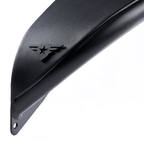 Close-up view of the edge of a front black aluminum fender flare for a Jeep Wrangler. The fender features a textured powder-coated finish and includes a removable and paintable Combat Off Road logo near the edge. Designed for durability and off-road performance, the fender flare also has pre-drilled holes for easy installation.