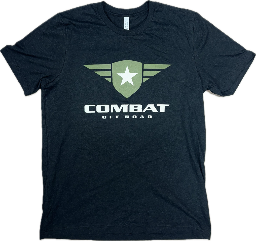 A black t-shirt featuring the Combat Off Road logo printed prominently on the chest. The logo includes a green shield with a white star and winged accents, with the text "Combat Off Road" in bold white letters underneath. The shirt has a classic crewneck design and short sleeves, suitable for casual wear.