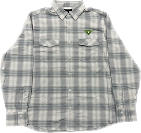 A light gray plaid button-up shirt featuring the Combat Off Road logo embroidered on the upper left chest. The logo includes a green shield with a white star and winged accents, accompanied by the text "Combat Off Road" in white. The shirt has two chest pockets with button closures, long sleeves, and a collar, offering a clean and versatile style.