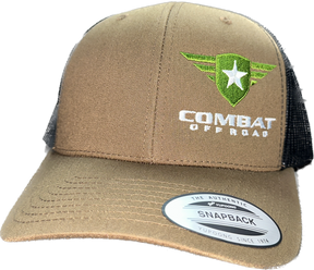 A tan and black trucker-style snapback hat with the Combat Off Road logo embroidered on the front. The logo features a green shield with a white star and winged accents, accompanied by the text "Combat Off Road" in bold white lettering. The front panel is tan, and the mesh back is black, with a sticker on the brim that reads "The Authentic Snapback". The hat has a curved brim for a comfortable fit.