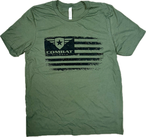 A green t-shirt featuring a distressed black design of the Combat Off Road logo integrated into a stylized American flag. The logo, placed in the top left corner of the flag, includes a shield with a star and winged accents, accompanied by the text "Combat Off Road" in bold black letters. The shirt has a classic crewneck and short sleeves, offering a casual and rugged look.