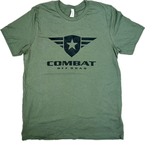 A green t-shirt featuring the Combat Off Road logo printed in black on the chest. The logo includes a shield with a star and winged accents, with the words "Combat Off Road" in bold black letters underneath. The shirt has a crewneck design and short sleeves, offering a comfortable and casual style.