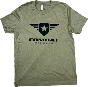 A olive t-shirt featuring the Combat Off Road logo printed in black on the chest. The logo includes a shield with a star and winged accents, accompanied by the text "Combat Off Road" in bold black letters underneath. The shirt has a crewneck design and short sleeves, offering a classic and comfortable fit.